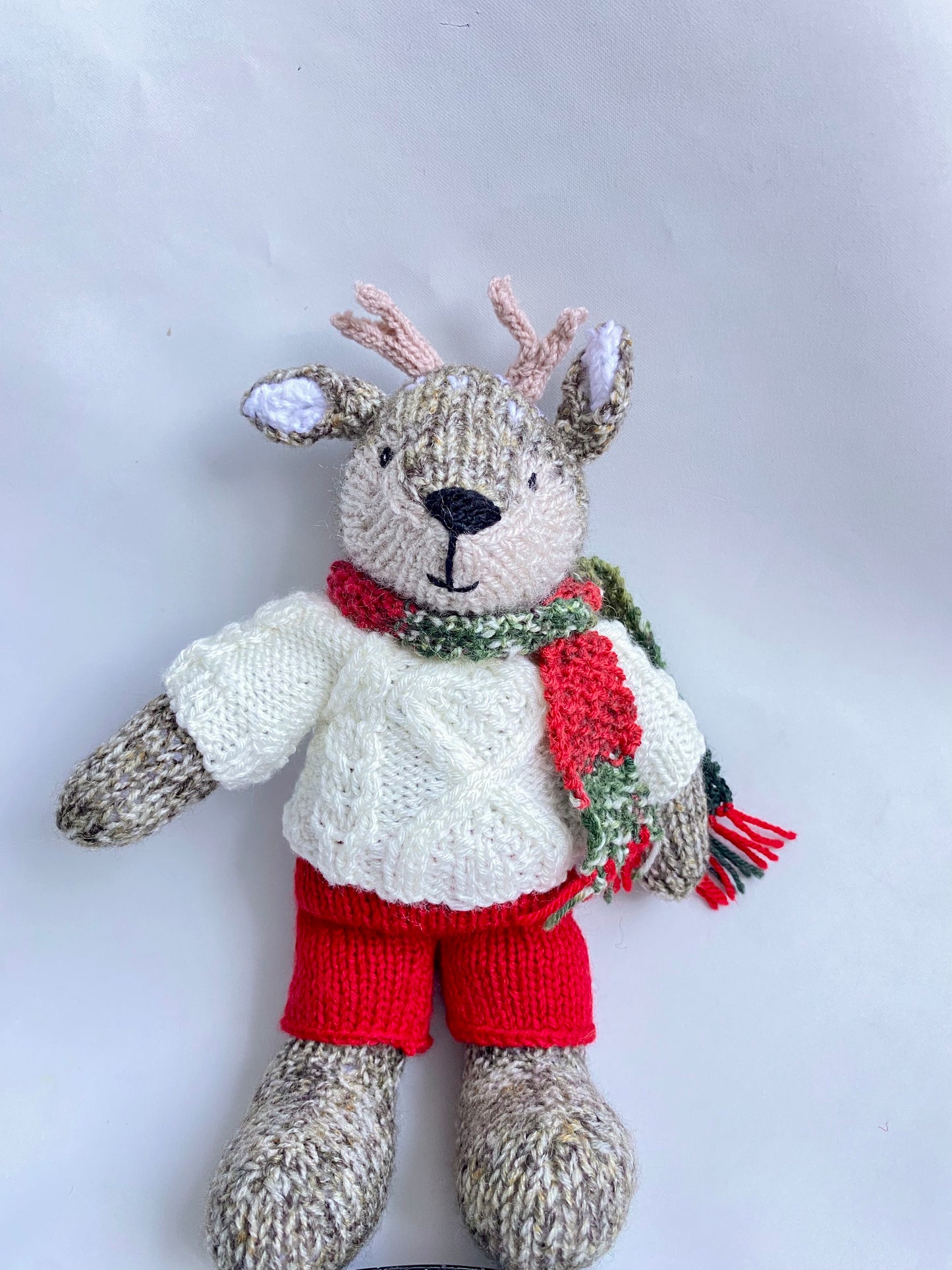 Hand knitted reindeer with cable jumper and scarf